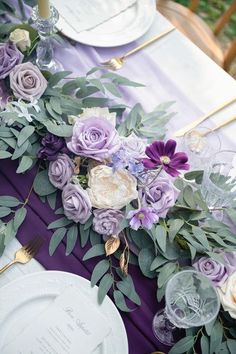 the table is set with purple flowers and greenery for an elegant wedding centerpiece