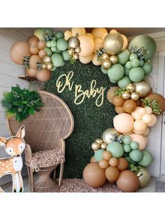 a baby's first birthday party with balloons and greenery on the front door