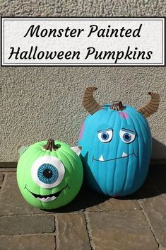 two pumpkins that have been decorated to look like monsters, one is blue and the other is green