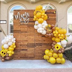 balloons and sunflowers are on display in front of a building