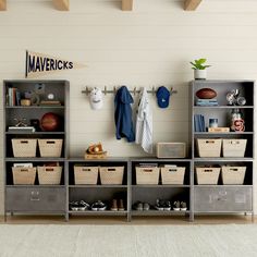 a room filled with lots of gray shelves and bins