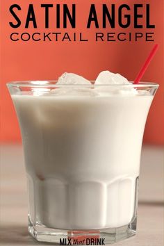 a glass filled with milk and ice sitting on top of a table