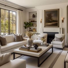 a living room with couches, chairs and a table in front of a fireplace