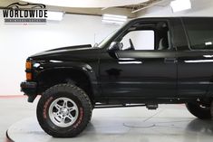 a black pickup truck parked in a garage