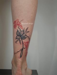 a woman's leg with a flower tattoo on it