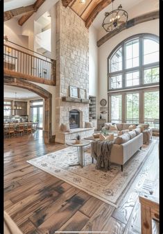 a large living room with high ceilings and wooden floors