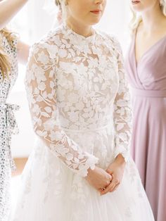 the bride is getting ready for her big day with her mother and sister in the background