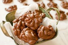 chocolate candies in a green bowl on a table