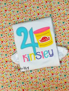 a birthday shirt with the number twenty on it and a bucket of candy in front