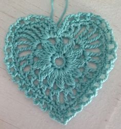 a crocheted heart hanging from a string