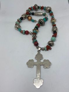 "This piece is so beautiful. It is a genuine, vintage, Taxco multi stone and sterling silver cross necklace. The necklace is 22 inches. The necklace features gorgeous, natural blue turquoise, red coral, carnelian, black onyx and sterling silver beads with a huge stamped sterling silver and black onyx cross. The stones are nuggets, round beads, rondelle beads. The sterling silver beads are stunning with etchings, including flowers, scrollwork, ribbed and other designs; some beads are shaped like Handmade Southwestern Cross Necklace, Southwestern Handmade Cross Necklace, Spiritual Cross Turquoise Necklace For Gift, Spiritual Turquoise Cross Necklace As Gift, Spiritual Turquoise Cross Necklace For Gift, Spiritual Turquoise Cross Necklace, Bohemian Cross Pendant Jewelry, Spiritual Turquoise Necklace With Cross Pendant Gift, Spiritual Turquoise Cross Pendant Necklace Gift