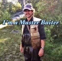 a man standing in front of a river holding a fishing rod and smiling at the camera