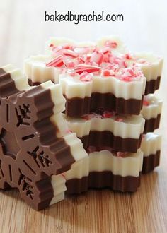 three pieces of chocolate with candy canes in them on top of a wooden table