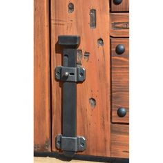 an old wooden door with metal handles and knobs