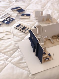 a model of a house sitting on top of a bed