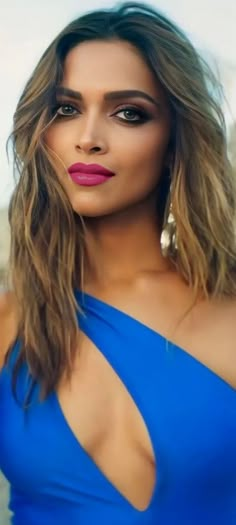 a woman in a blue dress posing for the camera