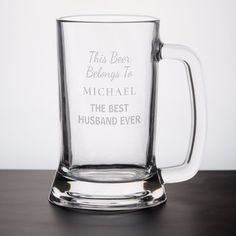 a glass mug that says, this beer belongs to michael the best husband ever