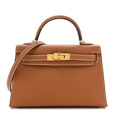 This is an authentic HERMES Epsom Mini Kelly Sellier 20 in Gold. This stunning Hermes classic handbag is beautifully crafted in stamped epsom calfskin leather in golden brown leather. A single rolled leather top handle is secured with polished palladium gold hardware and an optional leather shoulder strap is included. The traditional Kelly turn lock secures the small flap, which opens to a chevre goatskin leather with a flat pocket. Kelly Sellier, Mini Kelly, Classic Handbags, Hermes Bag, Golden Brown, Leather Top, Gold Hardware, Top Handle, Calf Skin