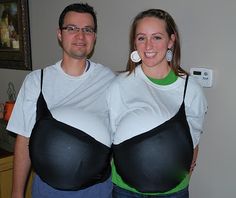 a man and woman dressed up in black and white outfits, standing next to each other