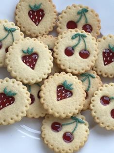 small cookies decorated with cherries on a plate