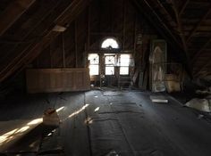 an old attic with wooden floors and windows