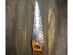 a pair of scissors sitting on top of a wooden table next to a christmas tree