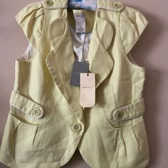 Pale Yellow Jacket In The Style Of Vest Made Of Cotton And Linen. The Pit To Pit Is Approximately 20 Inches And The Length Is Approximately 21 Inches Spring Fitted Outerwear With Pockets, Single Breasted Tailored Vest For Spring, Spring Tailored Single-breasted Vest, Tailored Casual Vest For Spring, Casual Tailored Tops For Spring, Fitted Yellow Vest For Fall, Anthropologie Jacket, Yellow Jacket, The Pit