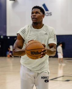 a man holding a basketball in his right hand