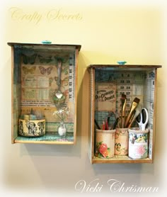 two wooden boxes with craft supplies in them hanging on the wall next to each other