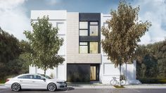 a white car parked in front of a tall building with trees on the side of it