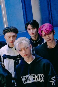 four young men with pink hair and piercings