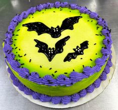 a cake decorated with purple icing and bats