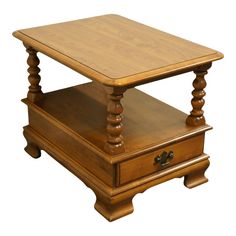 a wooden table with two drawers on each side and an open drawer under the top