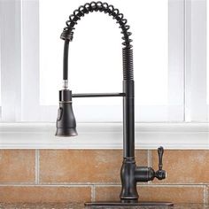 a kitchen faucet that is on top of a sink in front of a window