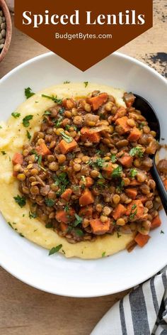 a white bowl filled with lentils and mashed potatoes on top of a wooden table