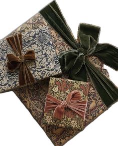 three wrapped gift boxes with bows on them