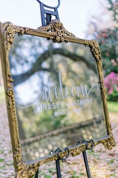 a welcome sign is placed in front of a mirror