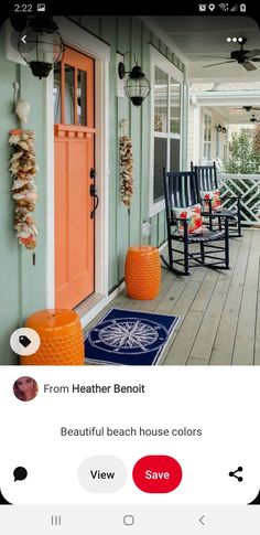 the front porch is decorated with orange and blue chairs, an orange rug, and two black rocking chairs