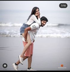 a man carrying a woman on his back at the beach