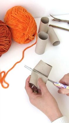 someone is doing something with yarn and scissors