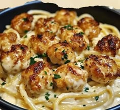 pasta with shrimp and sauce in a black bowl