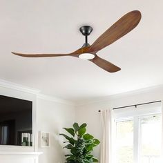 a living room filled with furniture and a ceiling fan