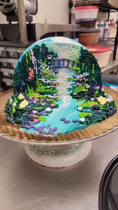 a cake that is on top of a plate in the shape of a bridge over a river