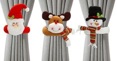 three christmas decorations hanging from the side of curtains with santa claus and snowman on them