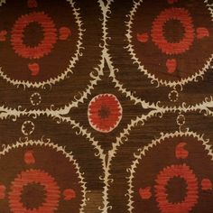 a brown and red area rug with hearts on the center, surrounded by smaller circles