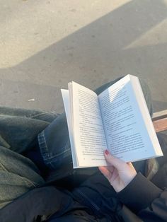 a person sitting down and reading a book