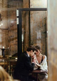 a man and woman sitting at a table in a restaurant