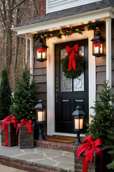 christmas decorations on the front door of a house with lights and wreaths around it