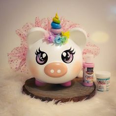 a white pig with a unicorn horn on it's head next to other items