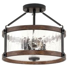 a semi flush light fixture with glass shades on the bottom and wood trimmings